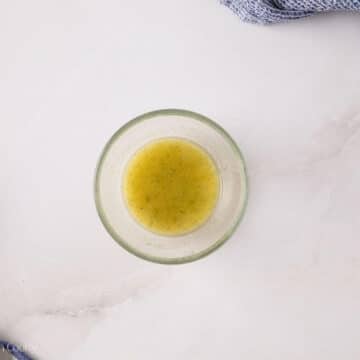 Butter, bacon grease and ranch dressing mix combined in a small glass bowl.