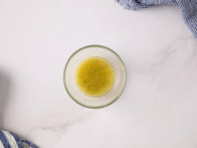 Butter, bacon grease and ranch dressing mix combined in a small glass bowl.
