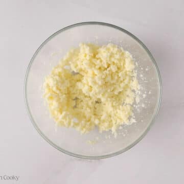 Butter and sugar creamed together in a mixing bowl.