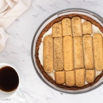 Layer of coffee soaked ladyfingers on top of the cheesecake layer.