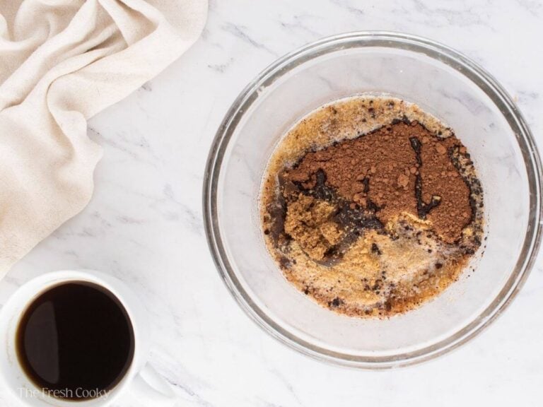 Ingredients for the graham cracker crust in a mixing bowl.