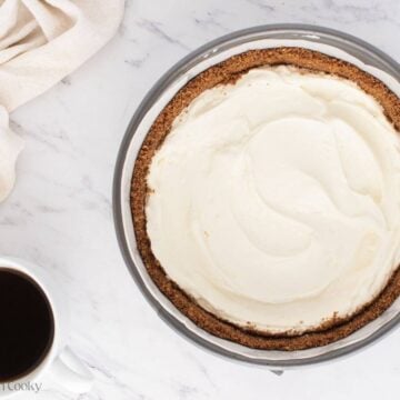 Layer of cream cheese filling in the graham cracker crust.
