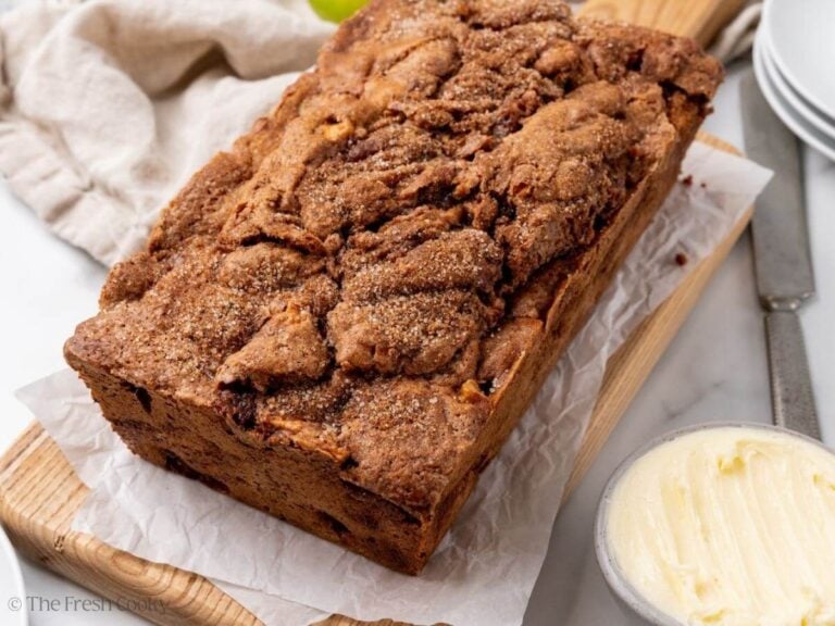 Apple cinnamon bread loaf on a wooden board.
