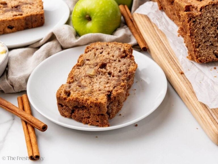 Thick slice of apple cinnamon bread on a plate.