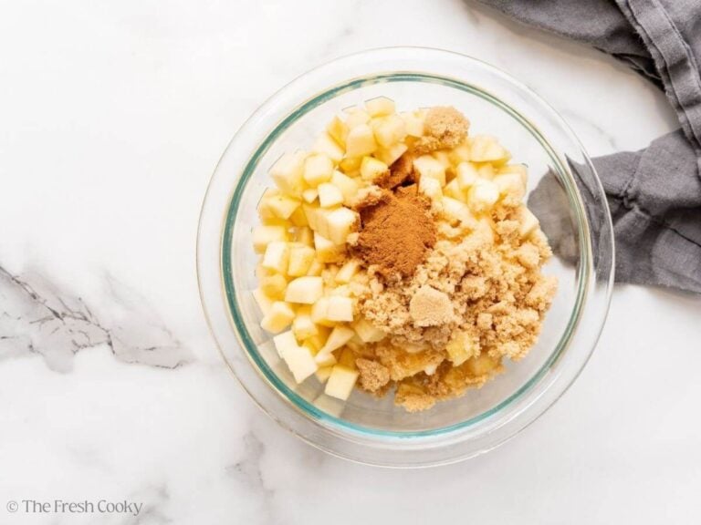 Apples, sugar and spices in a bowl.