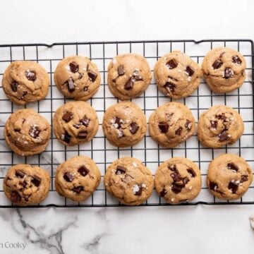 Cookies lined up on a wire cooling rack.