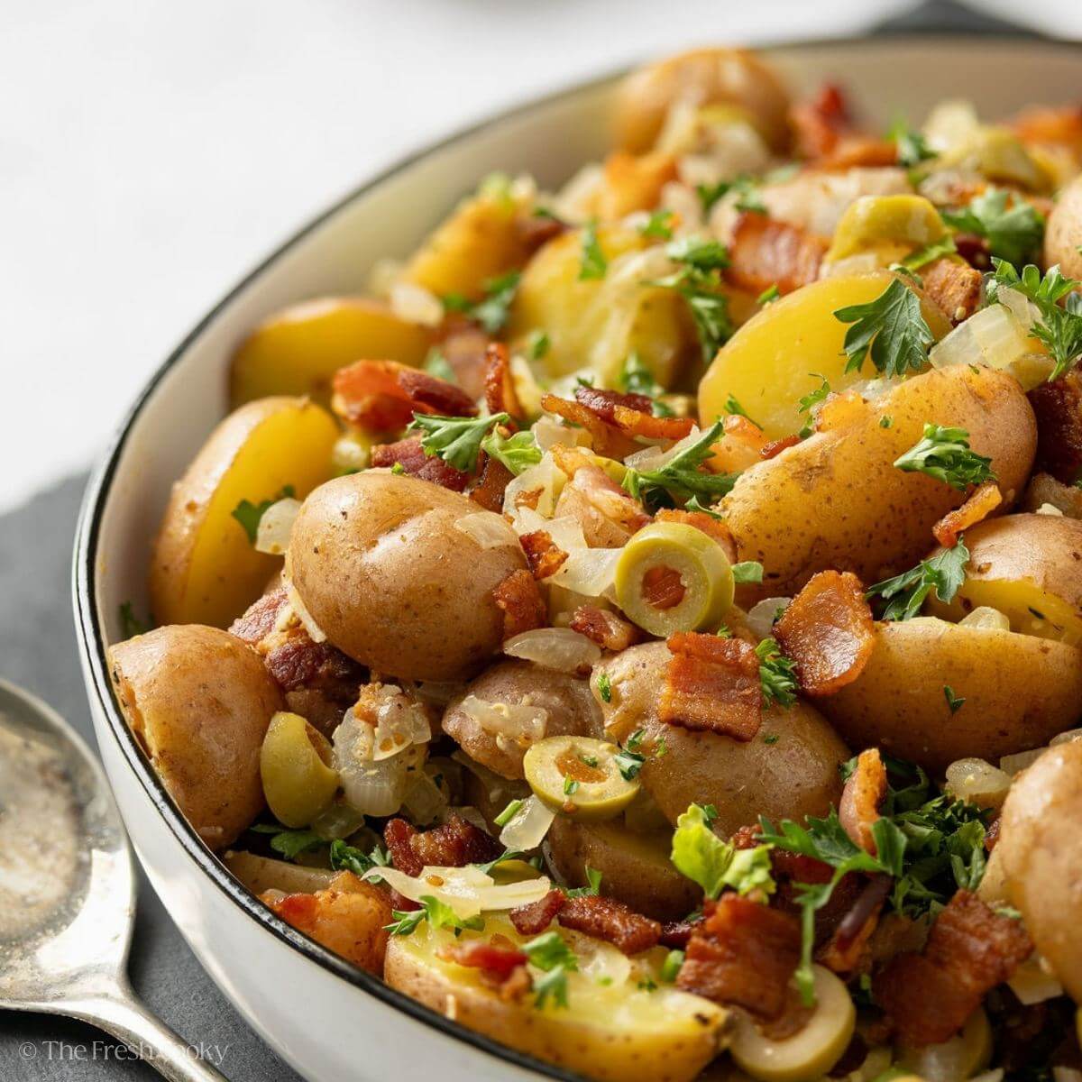 Side view of German potato salad in a serving bowl.