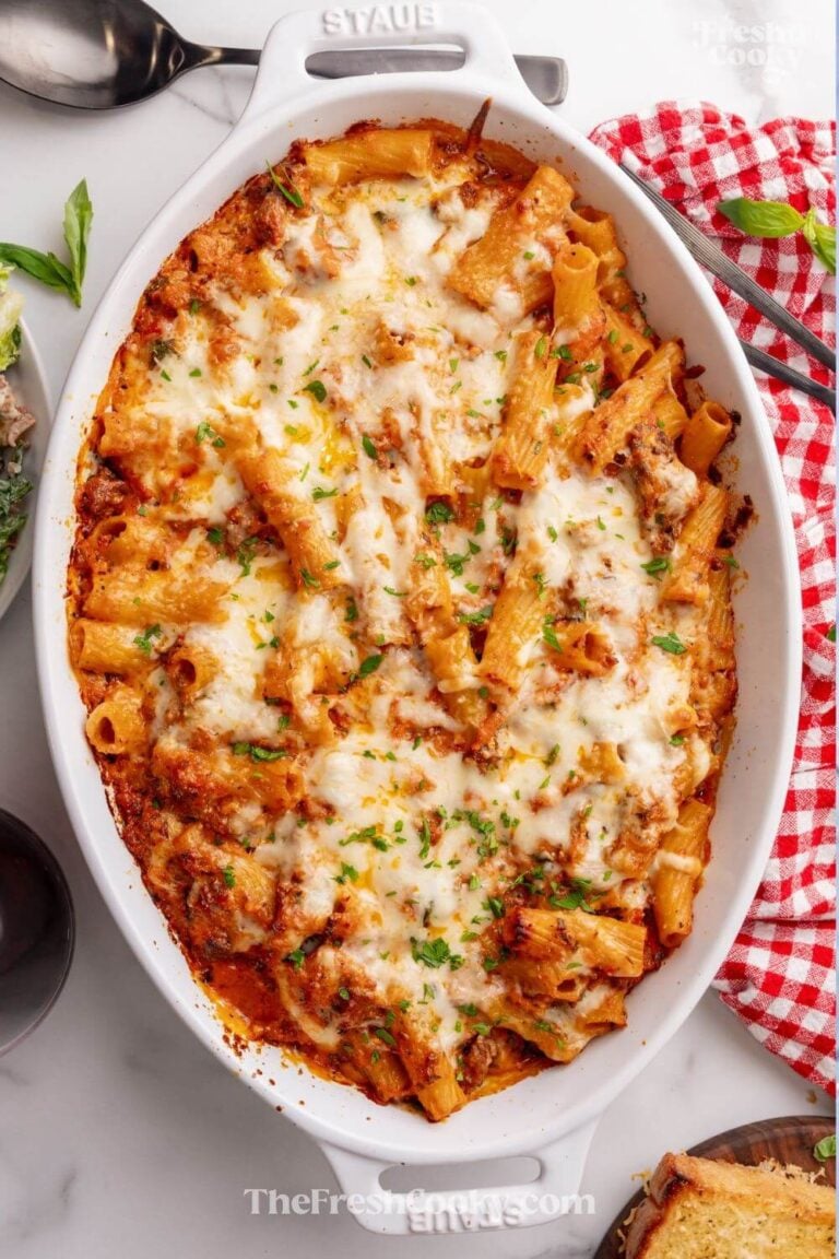Full pan of baked rigatoni topped with cheese, for pinning.