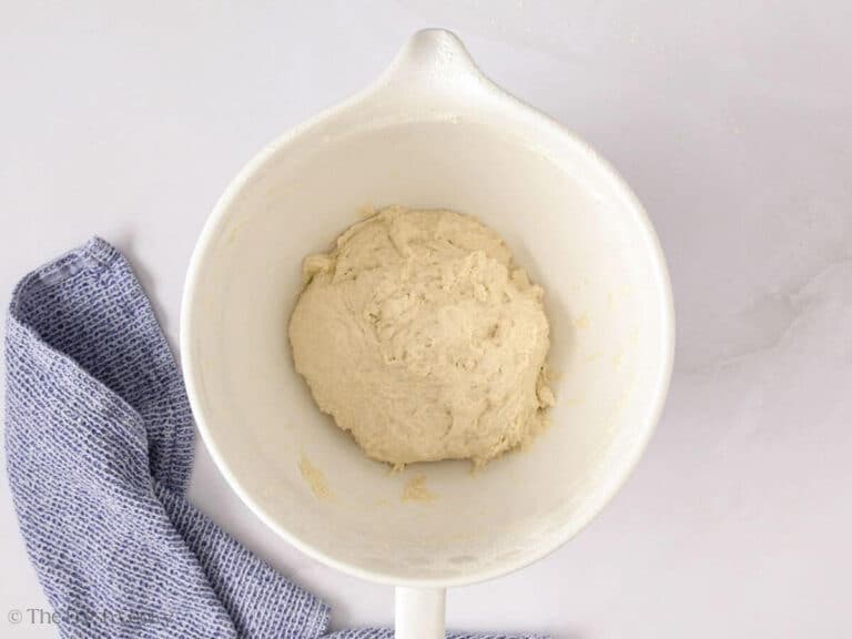 Bread dough in a stand mixer bowl after being mixed together.