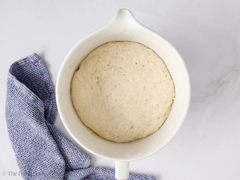 Italian bread dough in a mixing bowl after rising.