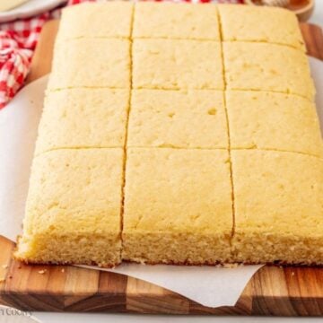 Sliced cornbread on a wooden board.
