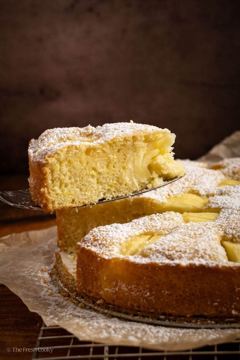 Spatula taking a slice of apple cake from the whole cake.