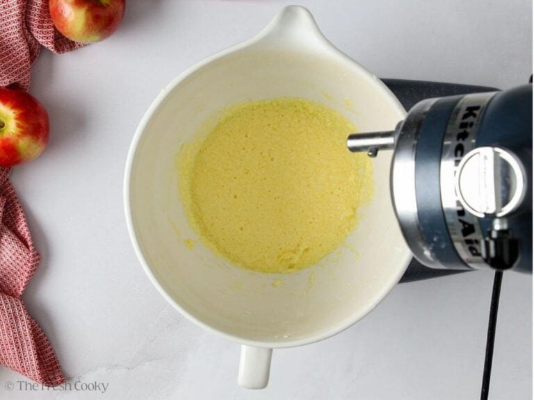 Eggs, vanilla, and lemon zest added to the butter and sugar in the bowl of a stand mixer.