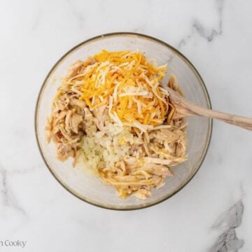 Shredded cheese and sauteed onions added to the shredded chicken mixture.