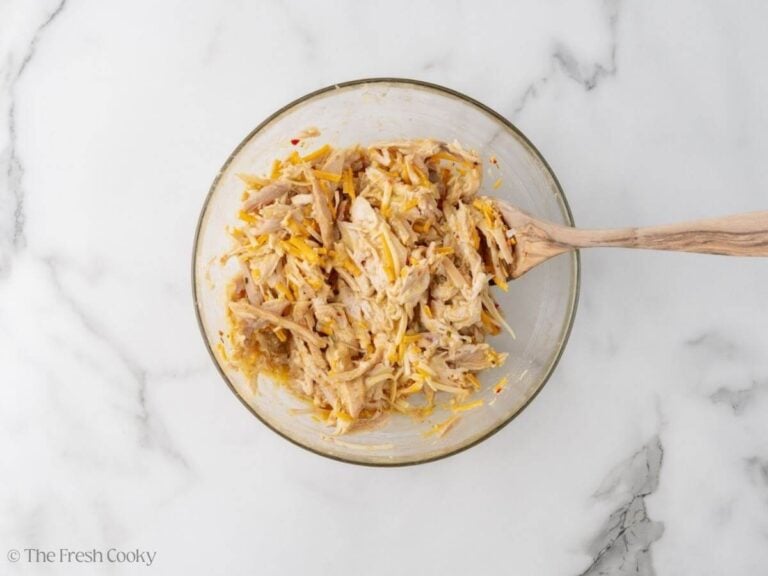 Shredded cheese and onions mixed into the shredded chicken.