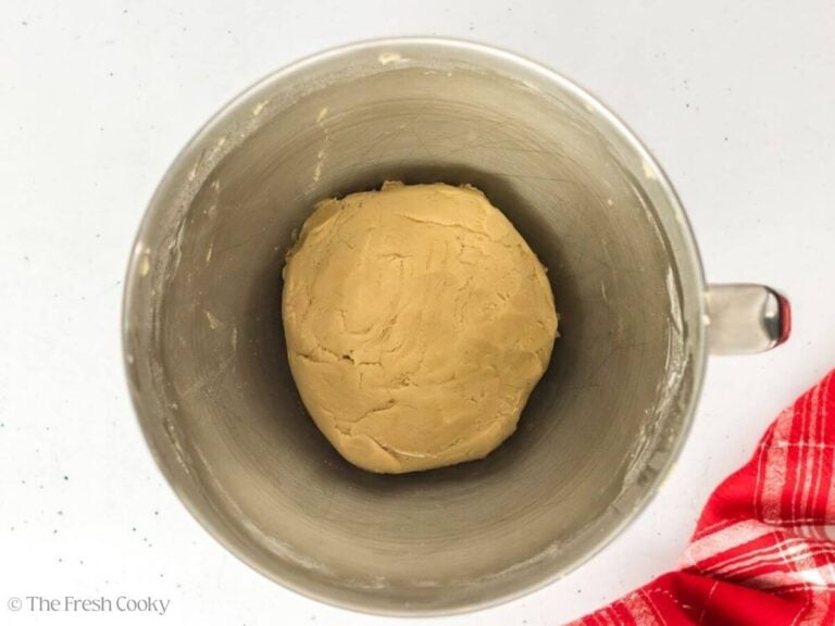 Cookie dough in the bowl of a stand mixer.