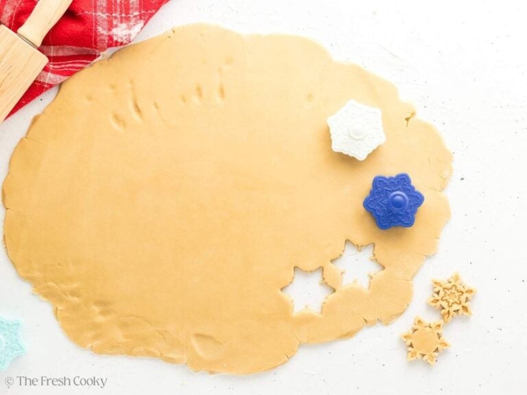 Snowflake shaped stamps pressed into the cookie dough.