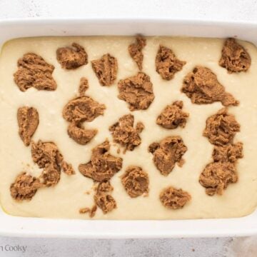 Brown sugar and butter mixture dolloped on top of the cake batter in a baking dish.