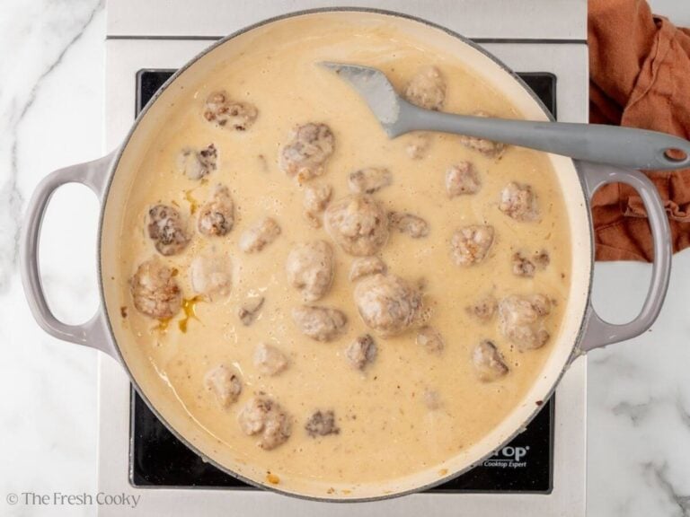 Finished Swedish meatballs in their sauce in a skillet.