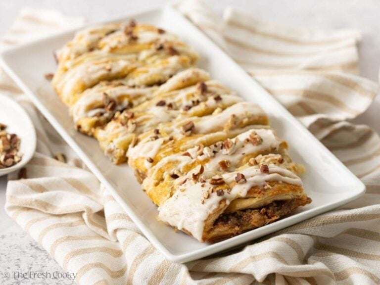 Danish kringle with pecan pie filling served on a serving dish.