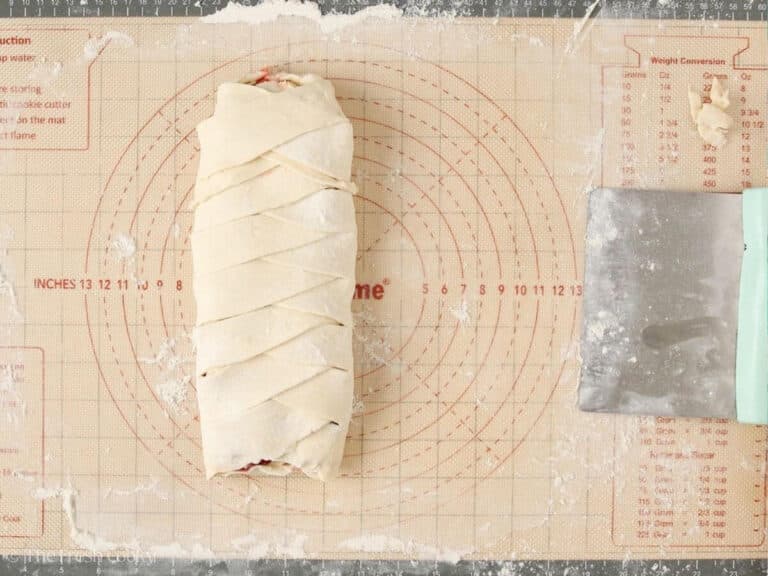 Assembled Danish kringle with cherry filling before being baked.
