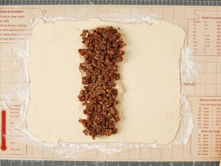 A second piece of kringle dough with cream cheese filling and pecan filling on top.