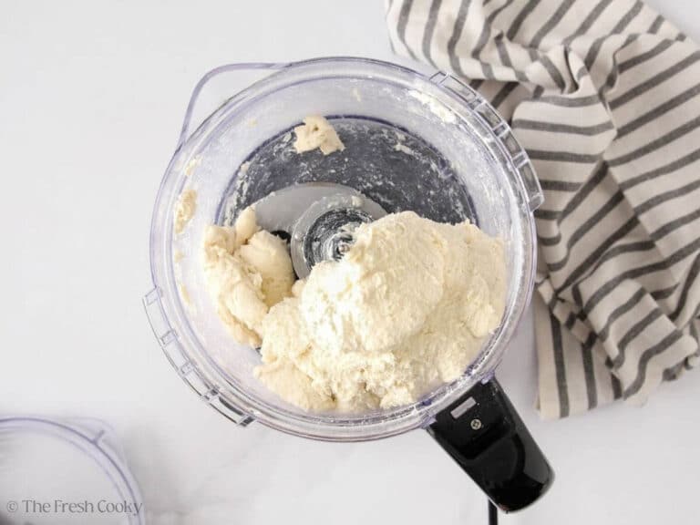 Butter and sour cream added to the flour in a food proccesor.