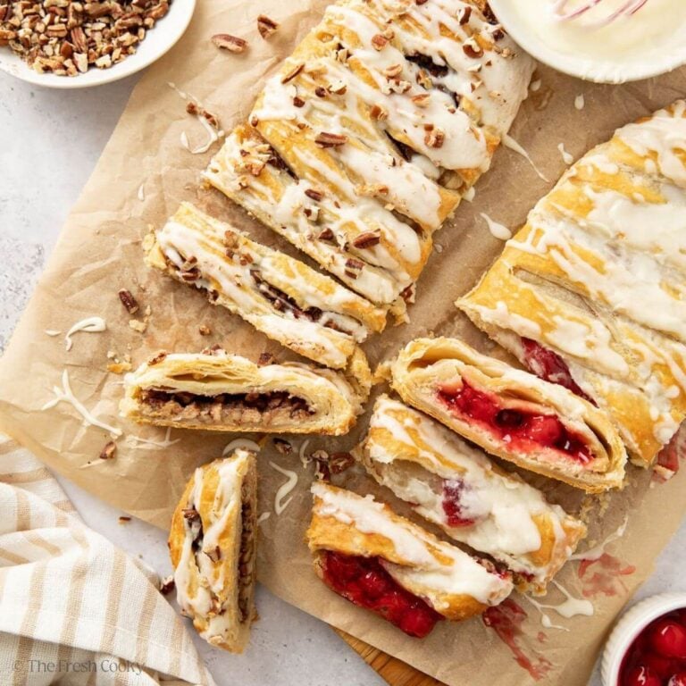 Sliced Danish kringles on a piece of parchment paper.