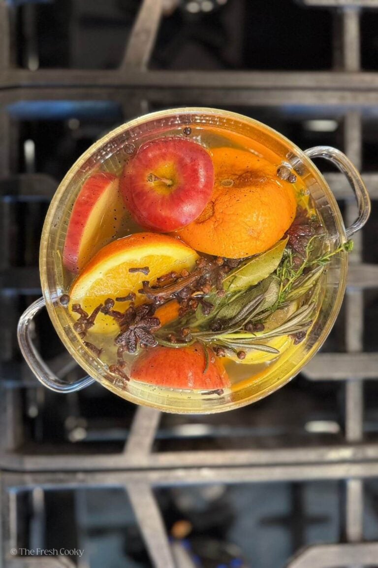 Overhead shot of fall simmering spices in a glass pot on the stove.