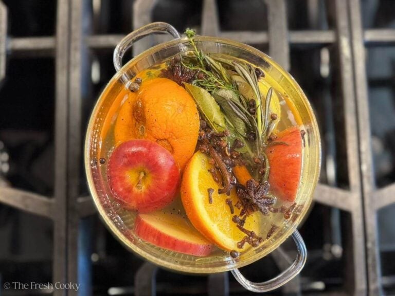 Fall simmering spices and fruits in a glass pot on the stove.