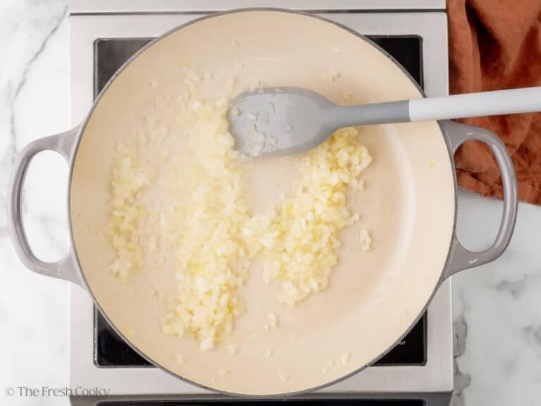 Onions sautéing in a in a skillet.