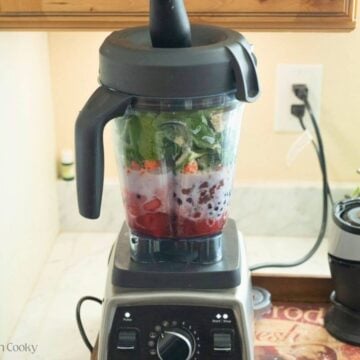 Side view of a blender with all of the ingredients added to it.