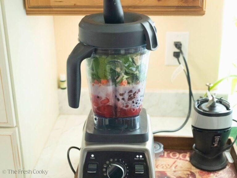 Side view of a blender with all of the ingredients added to it.