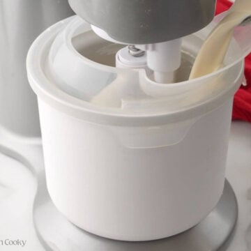 Pouring the peppermint ice cream mixture into an ice cream maker.