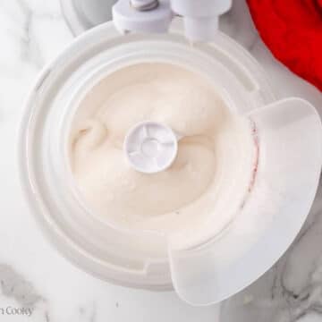 Peppermint ice cream churning in an ice cream maker.