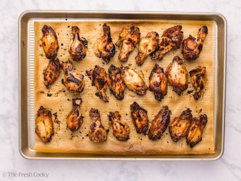 Broiled sticky chicken wings on a sheet pan.