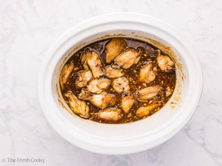 Wings cooked in a sauce in the slow cooker.