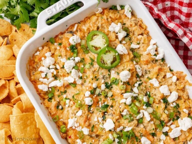 Overhead shot of Mexican street corn dip in a white baking dish with cotija cheese on top.