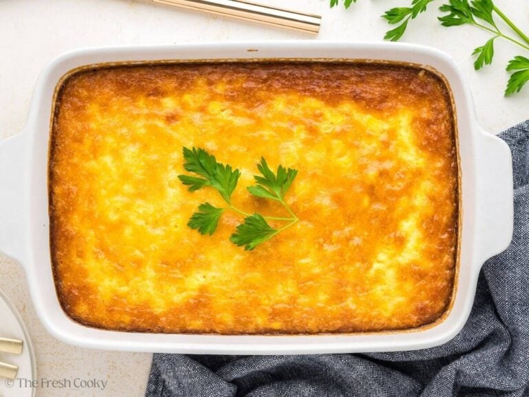 Overhead shot of finished corn casserole in a white baking dish.