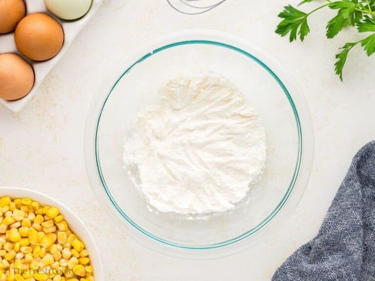Sugar, flour, baking powder and salt mixed together in a mixing bowl.
