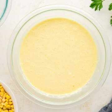 Wet and dry ingredients mixed together in a mixing bowl.