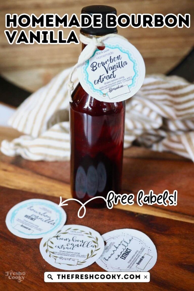 A bottle of dark liquid, filled with bourbon vanilla extract on a wooden board with various free labels, to pin.