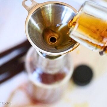 Add beans to bottle, then using a funnel pour in bourbon.