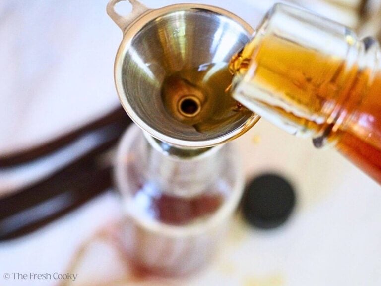 Add beans to bottle, then using a funnel pour in bourbon.