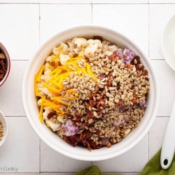 Crispy bacon pieces and sunflower seeds added to the bowl.