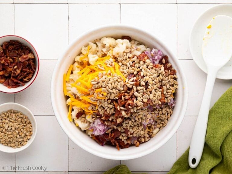 Crispy bacon pieces and sunflower seeds added to the bowl.