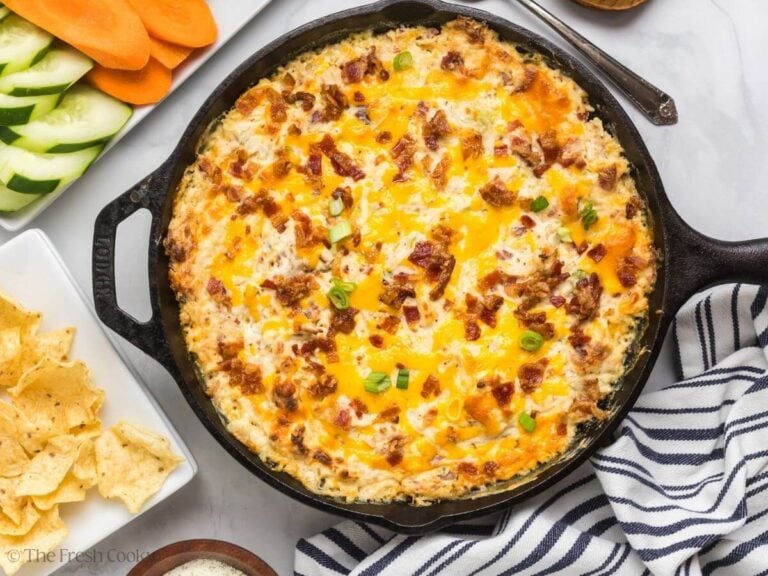 Chicken bacon ranch dip surrounded by veggies and tortilla chips.
