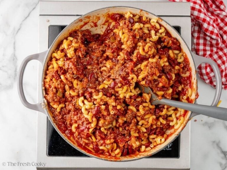 Chili mac mixture all mixed together in a skillet.