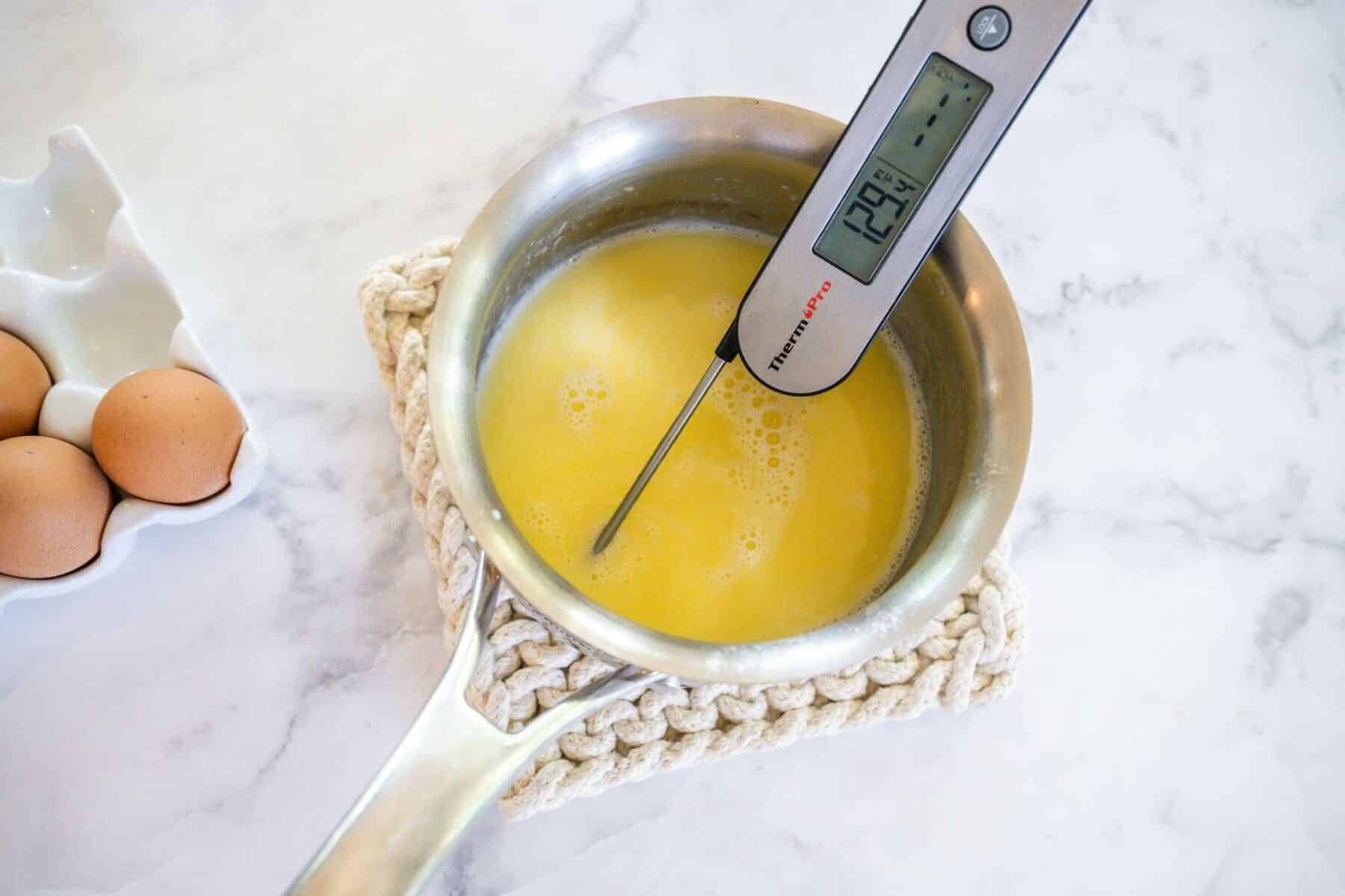 Thermometer in milk mixture for cinnamon rolls.