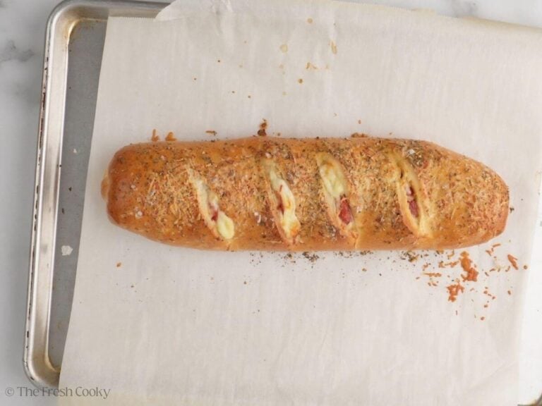 Baked pepperoni bread on a parchment-lined baking sheet.